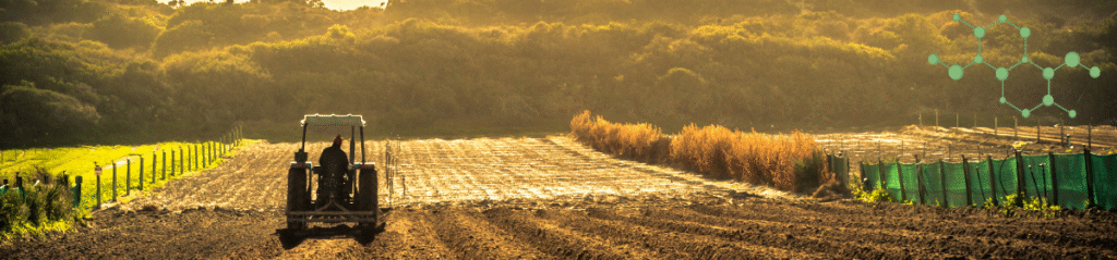 A farmer on a tractor ploughing a sunlit field, with a backdrop of green hills and a molecular structure overlay, symbolising agricultural innovation and chemical formulation.
