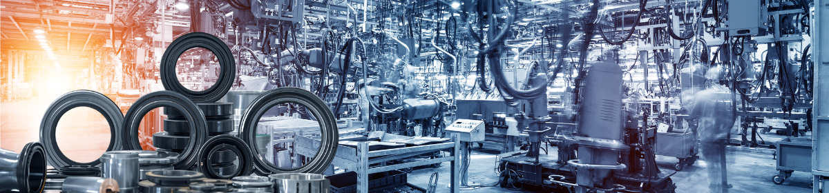 Automotive factory with machinery and rubber oil seals in the foreground.