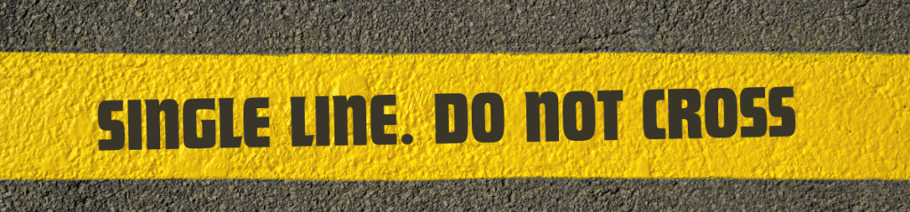 Yellow road marking with bold black text reading “SINGLE LINE. DO NOT CROSS,” symbolizing the lack of reasoning in the Stromag GmbH patent refusal—a single-line decision that violated principles of natural justice.