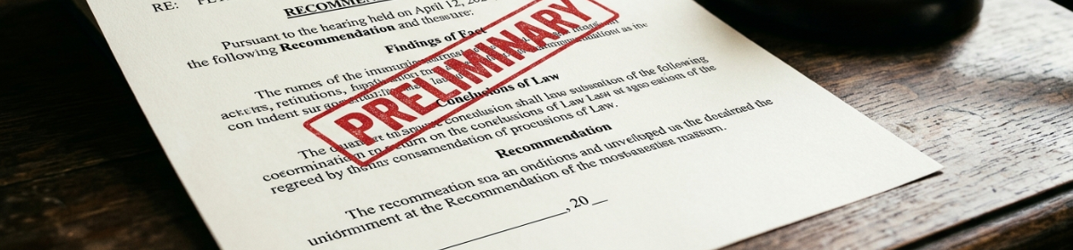 A close-up of a formal legal document stamped in red with the word "PRELIMINARY," resting on a dark wooden desk. The document shows sections headed "Findings of Fact," "Conclusions of Law," and "Recommendation," with a blank date line at the bottom. A gavel is partially visible in the upper right corner.