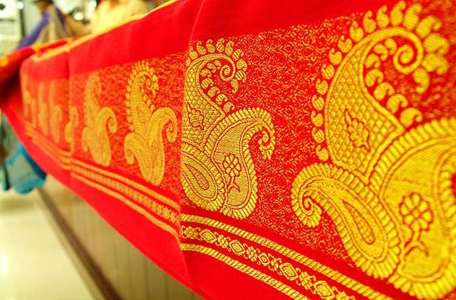 The image depicts a red mysore silk saree.