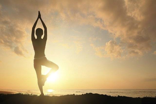 The image depicts a man in a yoga pose.