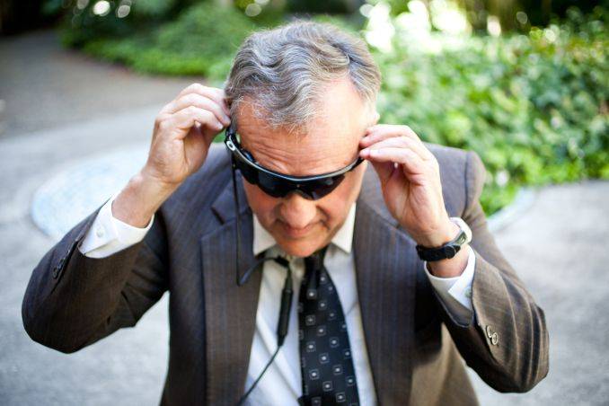 This image depicts a person wearing a black glass. This image is relevant as the post is about Wearable navigation assistance for the vision-impaired. Click on the image for more information
