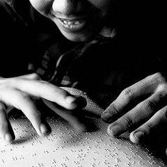 The featured image shows a boy smiling and reading a braille. The post is about Canada's ratification of the Marrakesh Treaty. To know more, please click here.