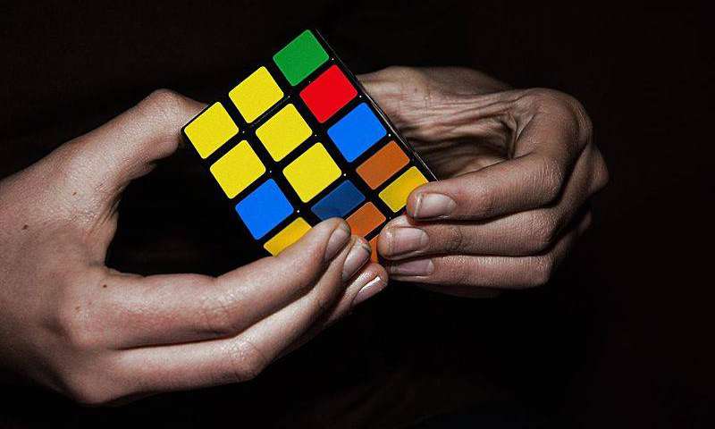The featured image shows a Rubik's cube and a person trying to figure the puzzle. The post is about the latest decision by the EU court regarding trademark over Rubik's cube. To know more, please click here.